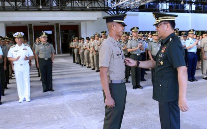 <p><strong>AWARDS FOR MARAWI HEROES. </strong>Armed Forces of the Philippines (AFP) Chief of Staff General Carlito Galvez Jr. pins the Gold Cross Medal to 1Lt George N Galzote, one of the 18 awardees during the flag-raising ceremony at the AFP General Headquarters Canopy Area in Camp Aguinaldo, Quezon City on Monday (May 28, 2018).<em> (Photo courtesy: AFP Public Affairs Office)</em></p>
